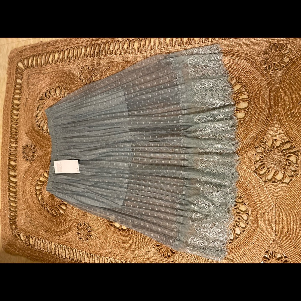 Sage colored laced skirt with a mini underlying skirt; floral-like edged hem